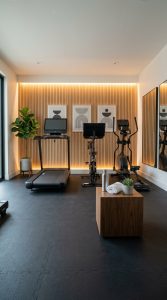 Aesthetic home gym cardio machine setup with rubber flooring and warm lighting